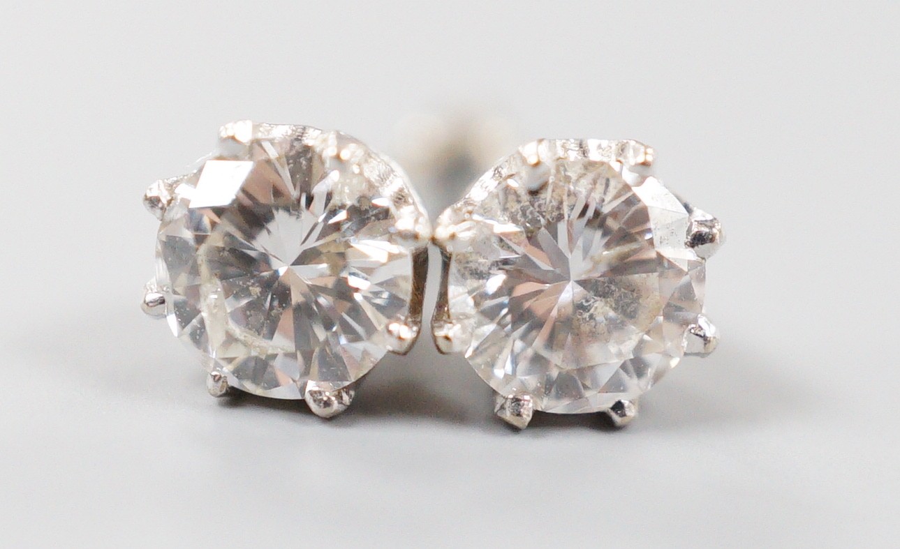 A modern pair of 18k white metal and solitaire diamond set ear studs (butterflies differ), gross weight 1.4 grams